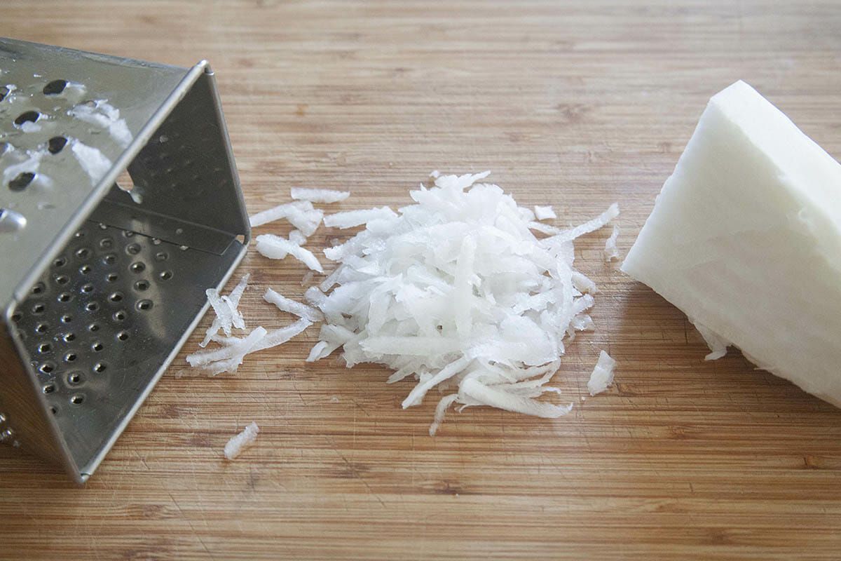 Diakon radish shredded with a box grater to make an easy homemade kimchi recipe.