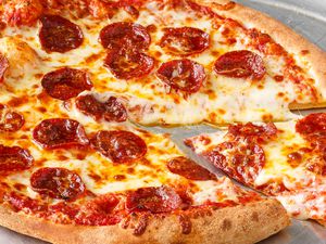 Pepperoni pizza with one slice partially removed
