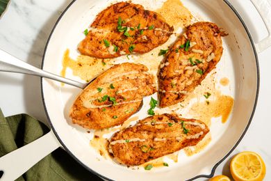 Overhead view of 4-ingredient Garlic-Tahini chicken breast cutlets cooking in a white skillet