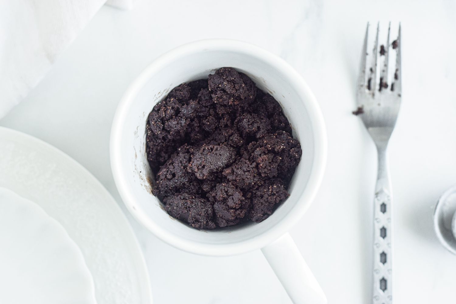 A fork stirring ingredients to make a Brownie in a Mug.