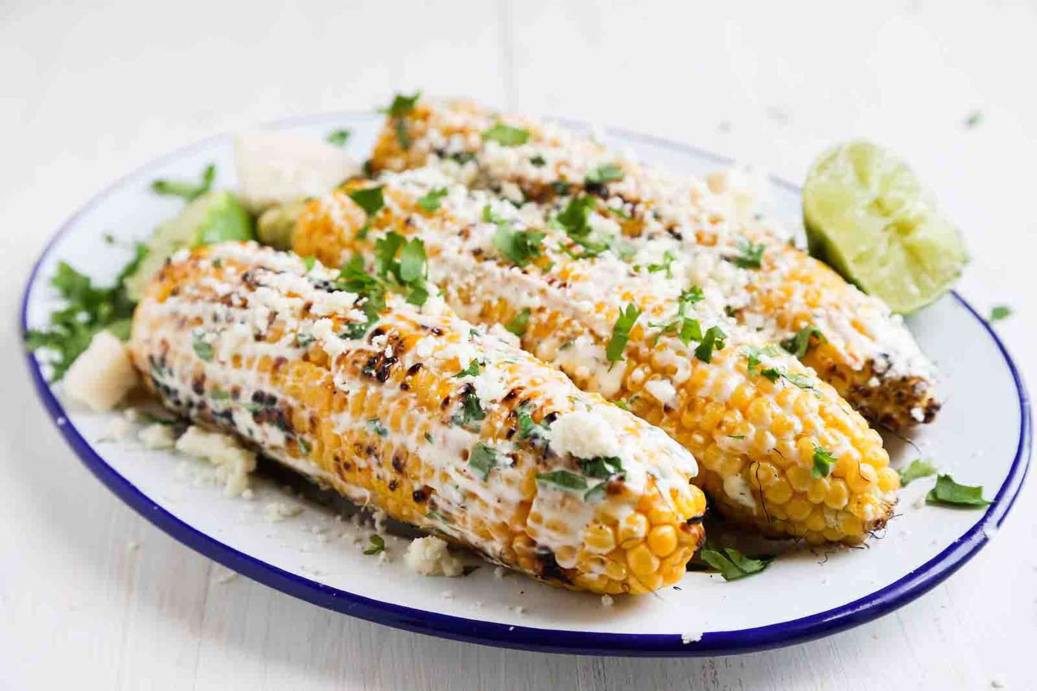 A platter of grilled Mexican street corn (elotes)