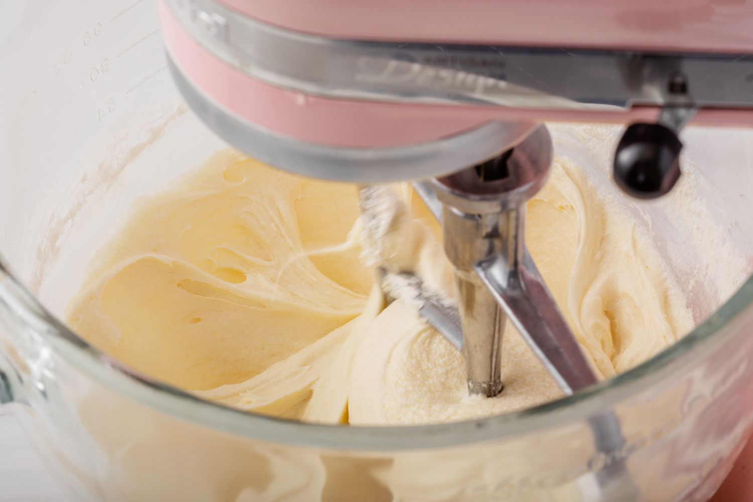 Batter for the best vanilla cupcake recipe in a glass stand mixer bowl.