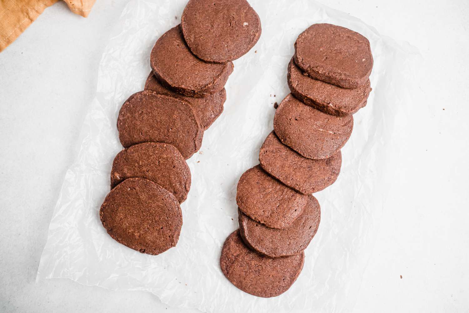 Simple chocolate shortbread shingled on a parchment paper.