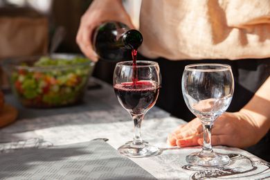 Red wine poured into wine glass