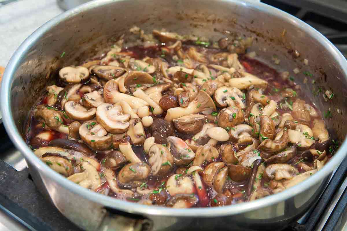 mushrooms being sauteed with butter and thyme