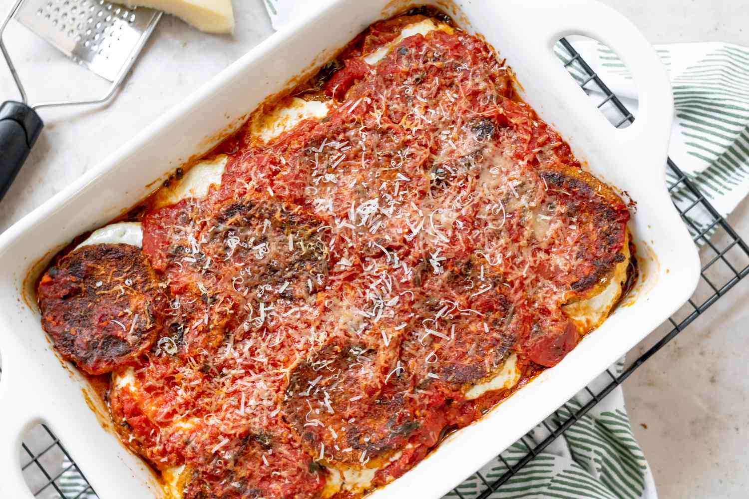 Baked eggplant parmesan in a casserole dish.