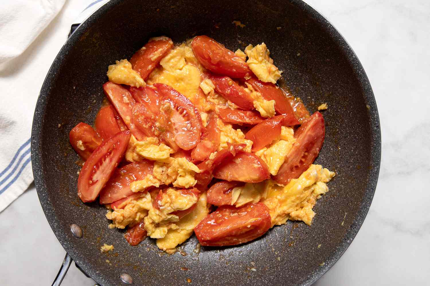 Overhead view of finished Chinese tomato egg in a skillet