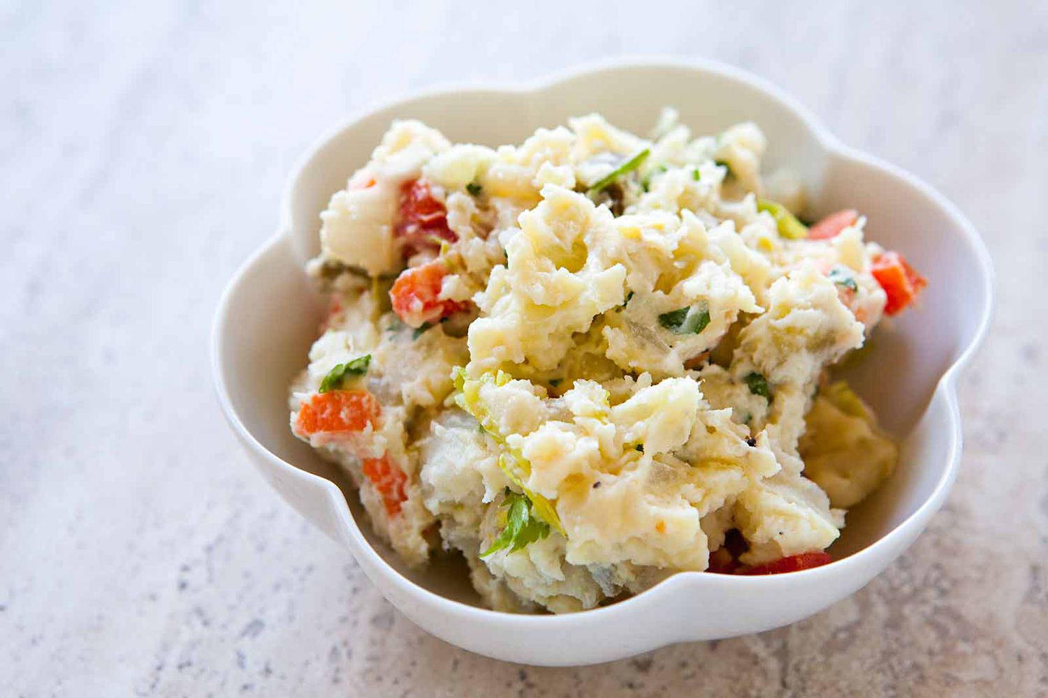 potato salad with egg and red pepper in a bowl