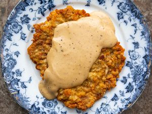 Easy chicken fried steak covered with gravy on a plate