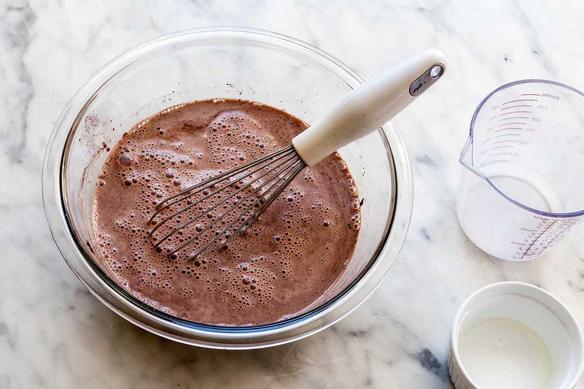 A Chocolate pie filling whisked in a glass bowl.