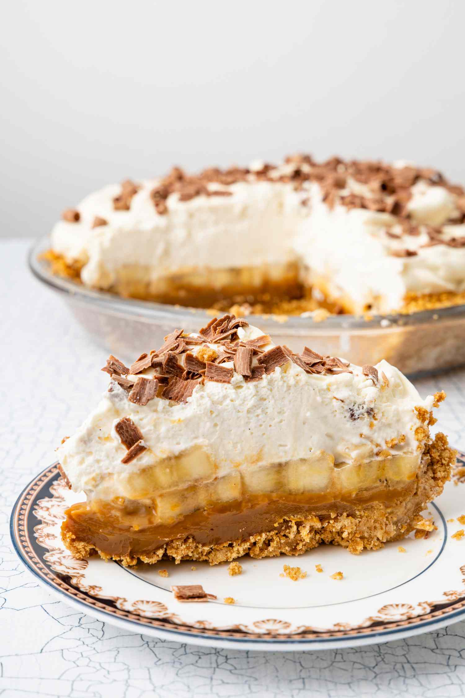Slice of Banoffee Pie on a Small Plate, and in the Background, More Pie in a Pie Pan