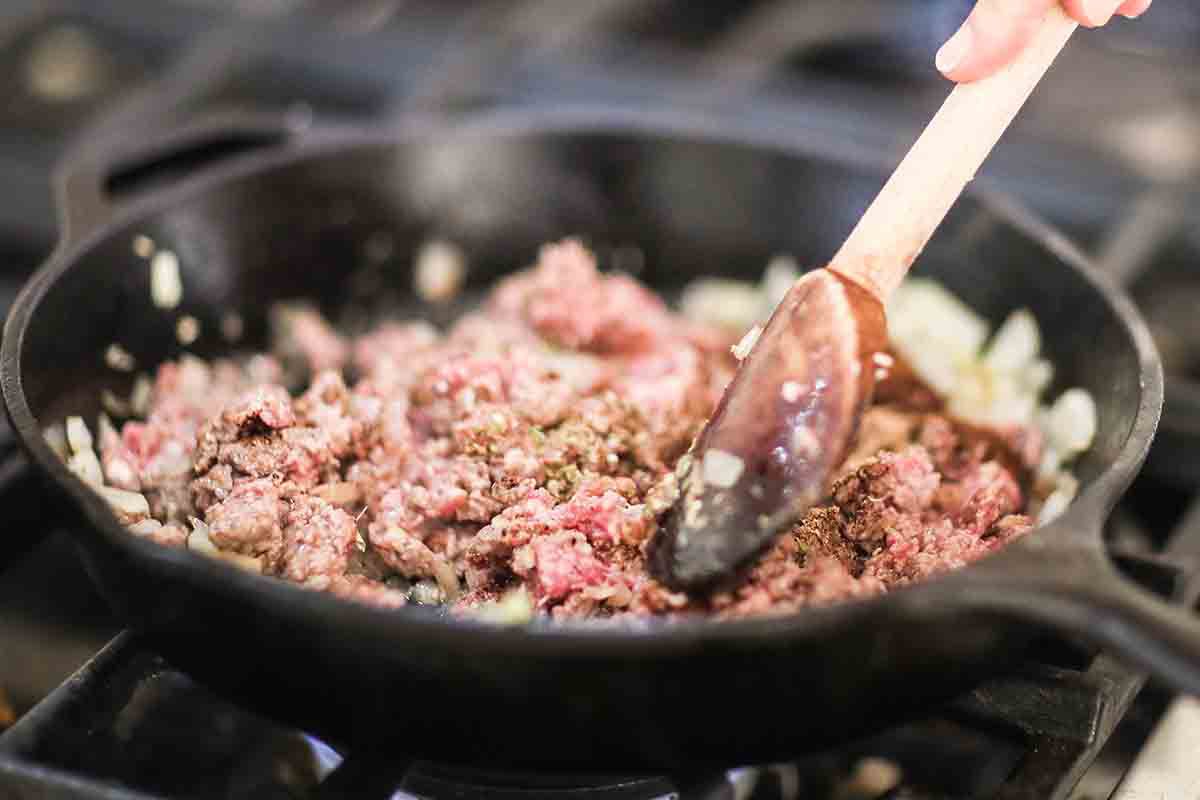 Sheet Pan Nachos with Black Beans cook the onions and beef