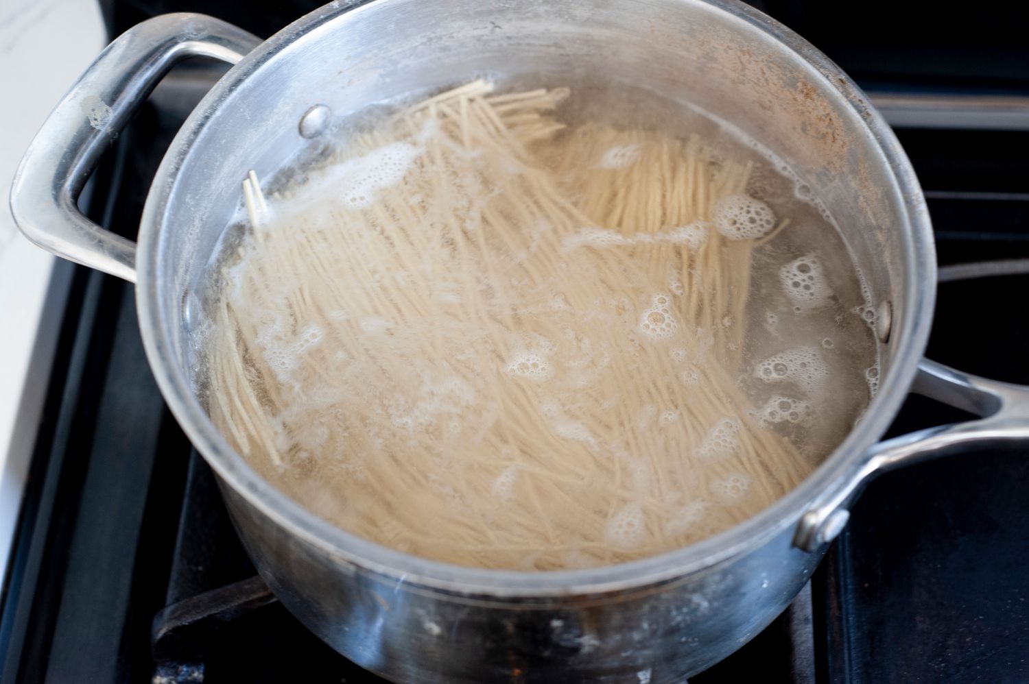 Noodles cooking in a pot.