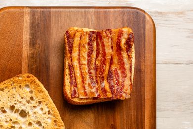 Crispy bacon on a slice of bread
