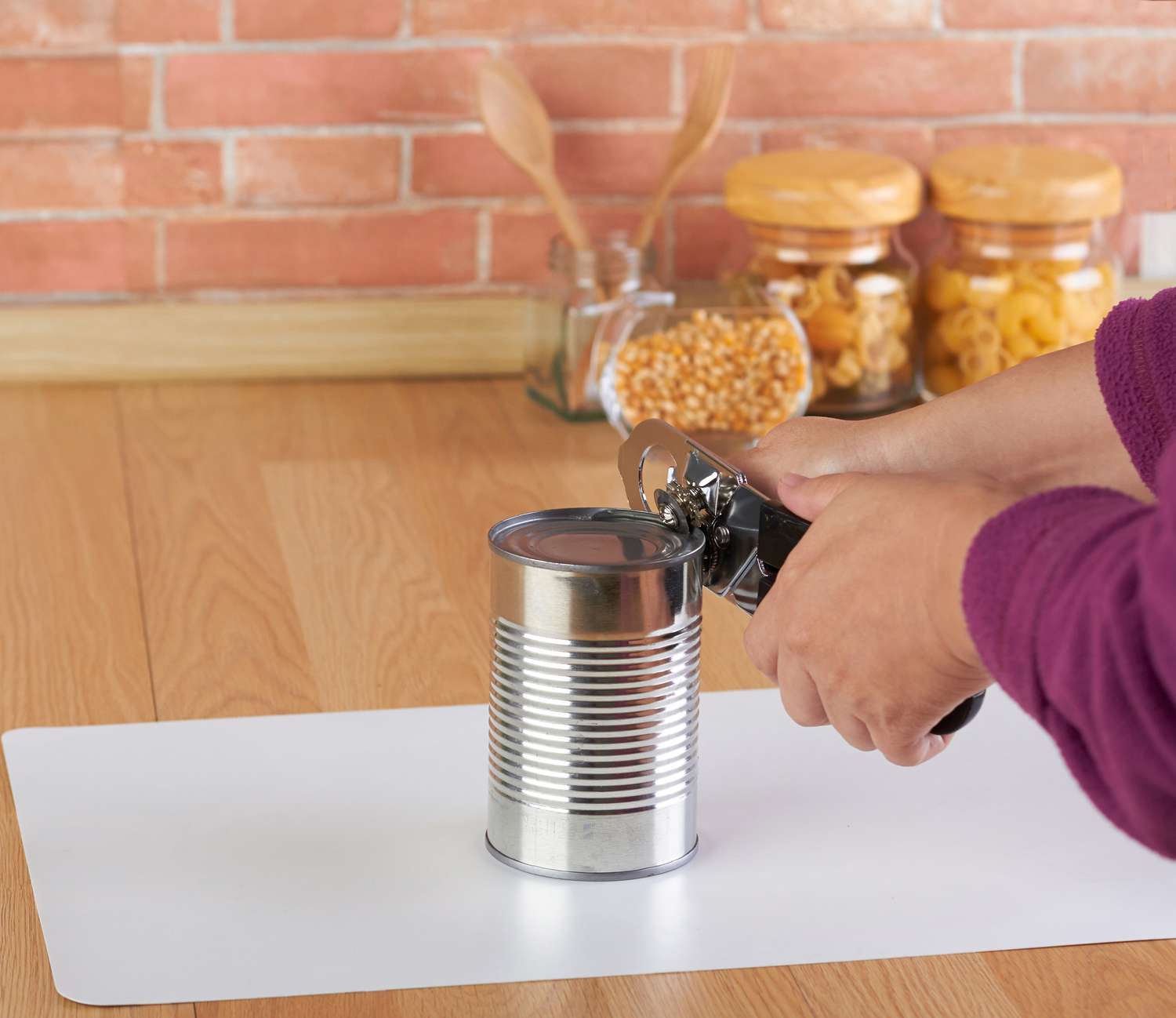 Woman opening a can of corn
