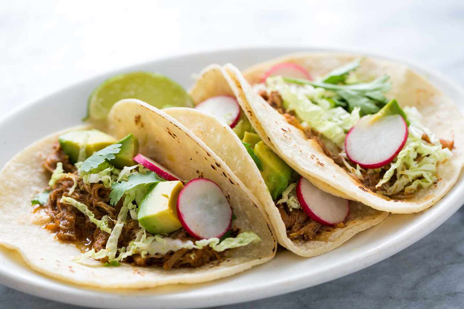 Slow Cooker Shredded Chicken Taco Meat with radish and avocado