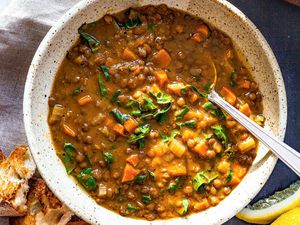 Vegetable Lentil Soup in a bowl with a spoons.