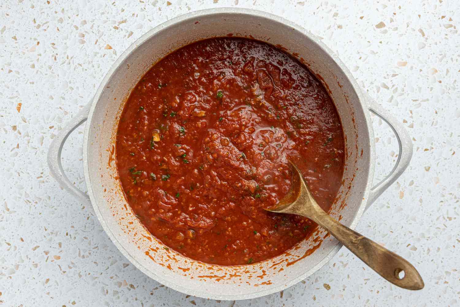 Spaghetti and Meatballs Sauce in a Pot, Mixed Using a Wooden Spoon