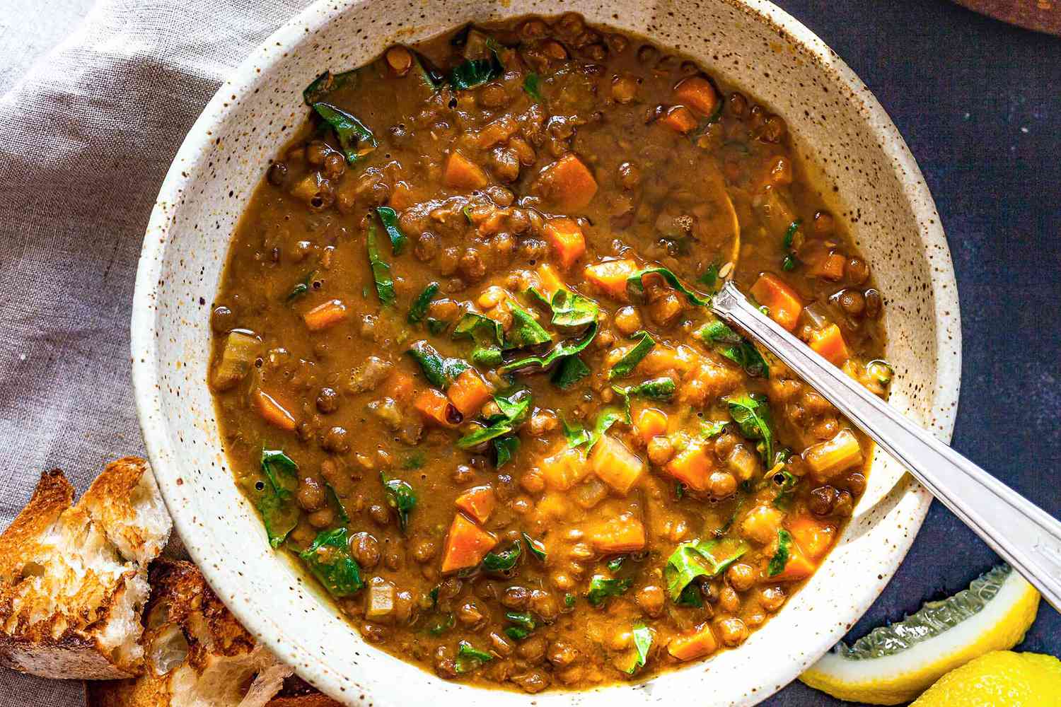 lentil soup in a bowl with a spoon