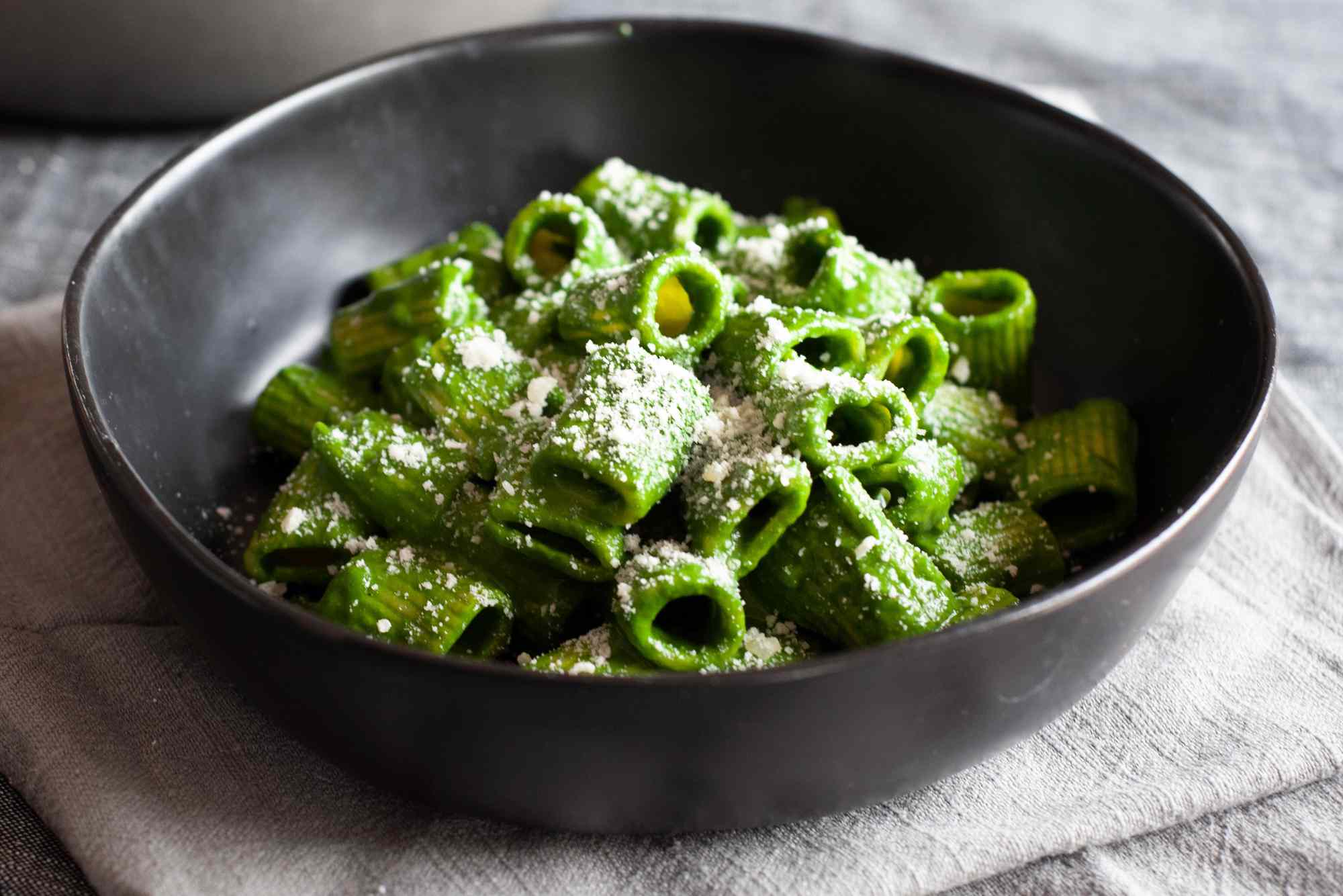 Swiss chard, lemon, and parmesan pasta heaped in a low bowl.