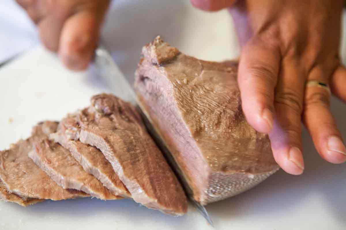 slice cooked cow tongue for tacos