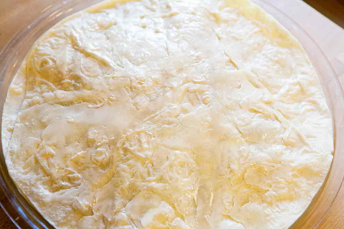 add a buttered tortilla to top the quesadilla pie