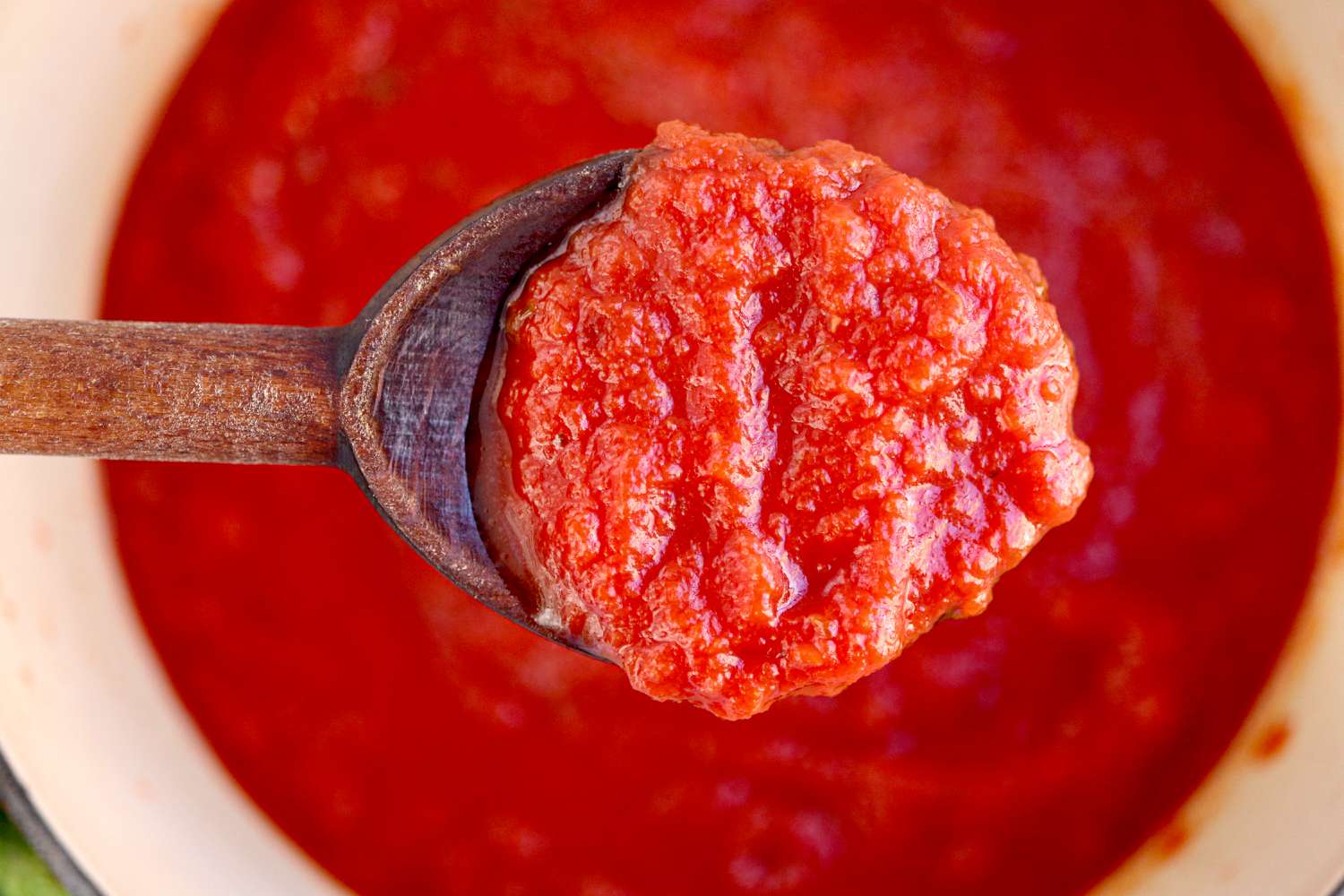 Homemade Pizza Sauce on a wooden spoon.