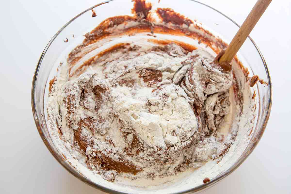 mixing flour into bittersweet chocolate cake batter