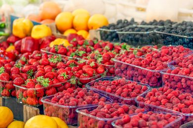 fresh summer berries (strawberries, raspberries, and blackberries) in countainers 