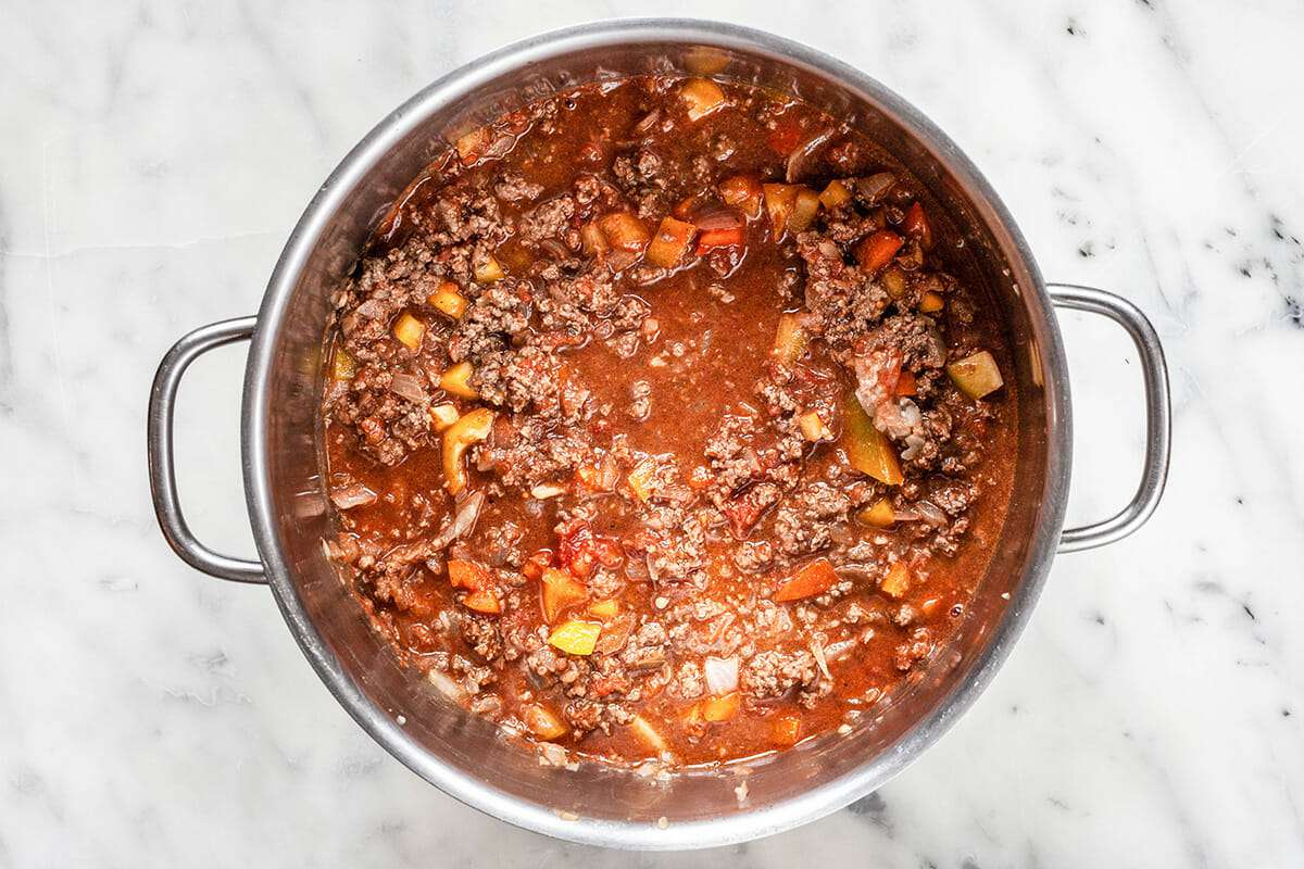 Ground beef chili simmering in a large stock pot.