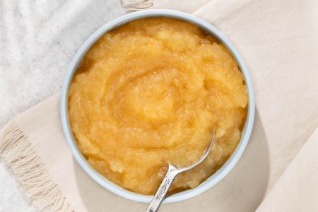 Microwave Applesauce in a bowl with a spoon