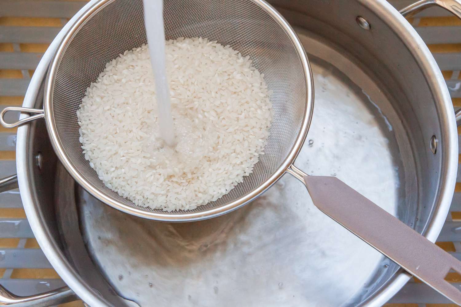 Rice in a Strainer over a Bowl with Water Running through It (Method 1)
