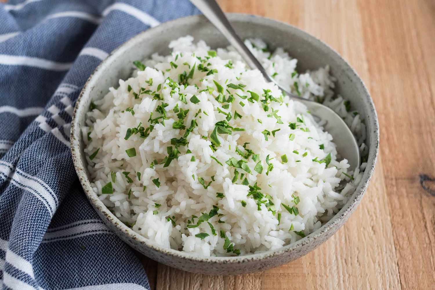 cooked rice with herbs in a bowl