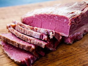Home cured corned beef sliced on a cutting board