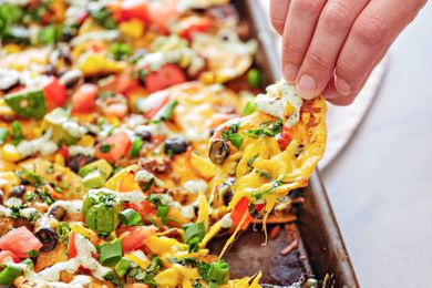 Pulling a loaded chip away from a sheet pan of nachos