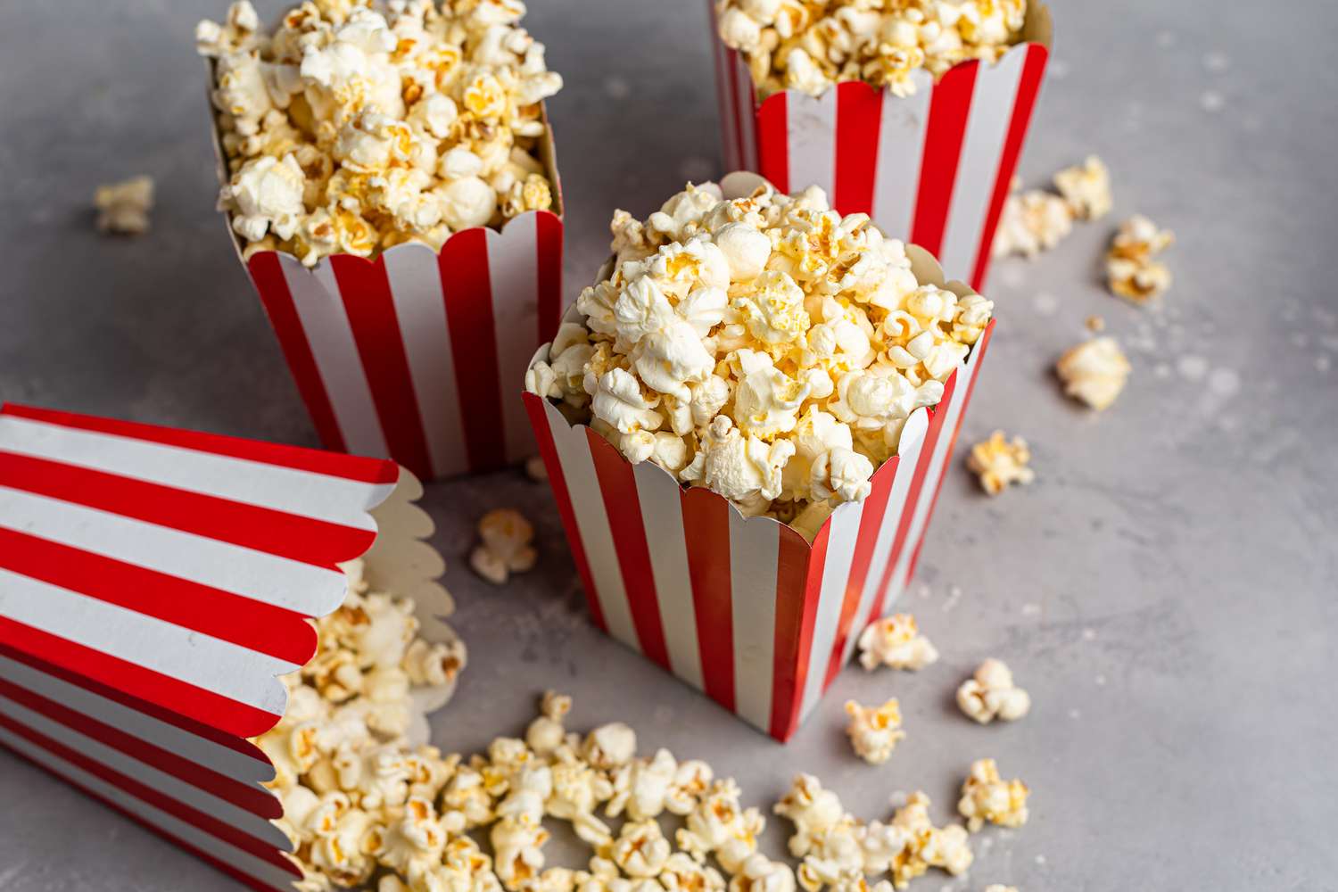 Red striped paper cartons overflowing with popcorn recipes
