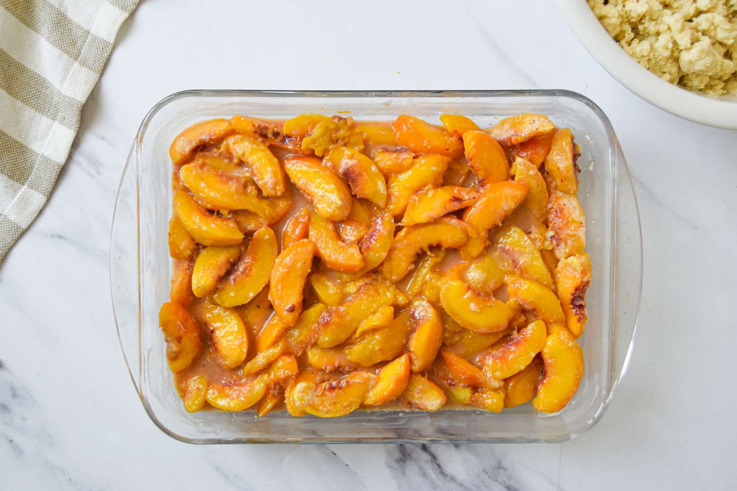 Macerated Peaches in the Baking Dish for Peach Cobbler Recipe