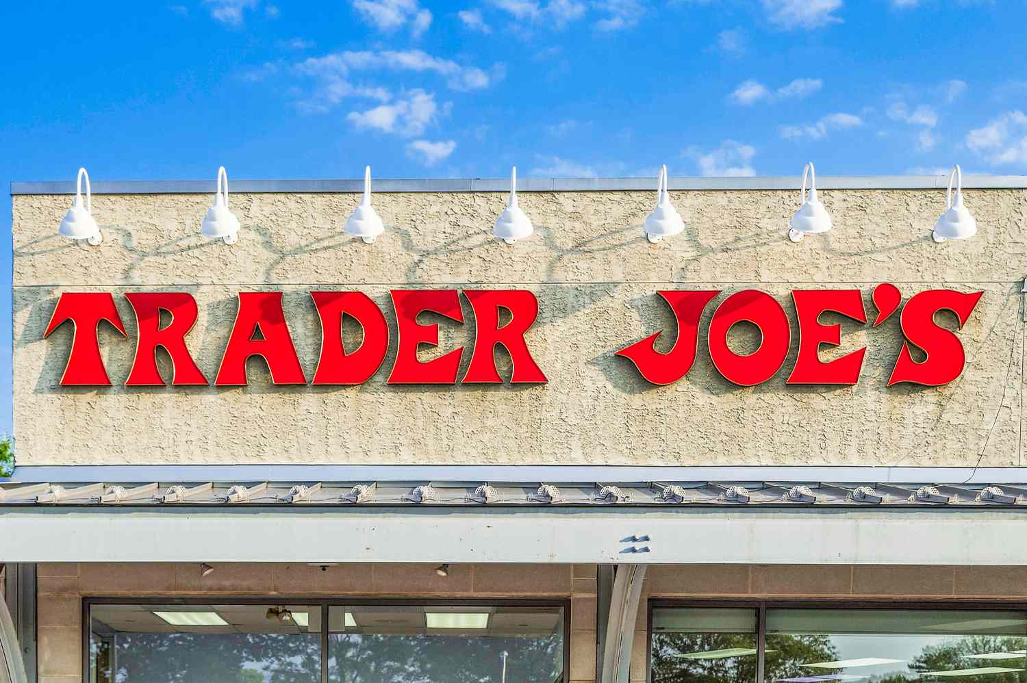 Trader Joe's store sign against a blue sky