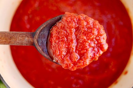 Homemade Pizza Sauce on a wooden spoon.