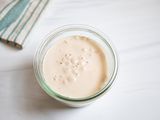 A glass cup of proofed yeast.