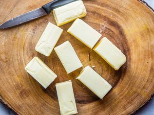 Ghee Clarified Butter Recipe - sticks of butter on wooden platter