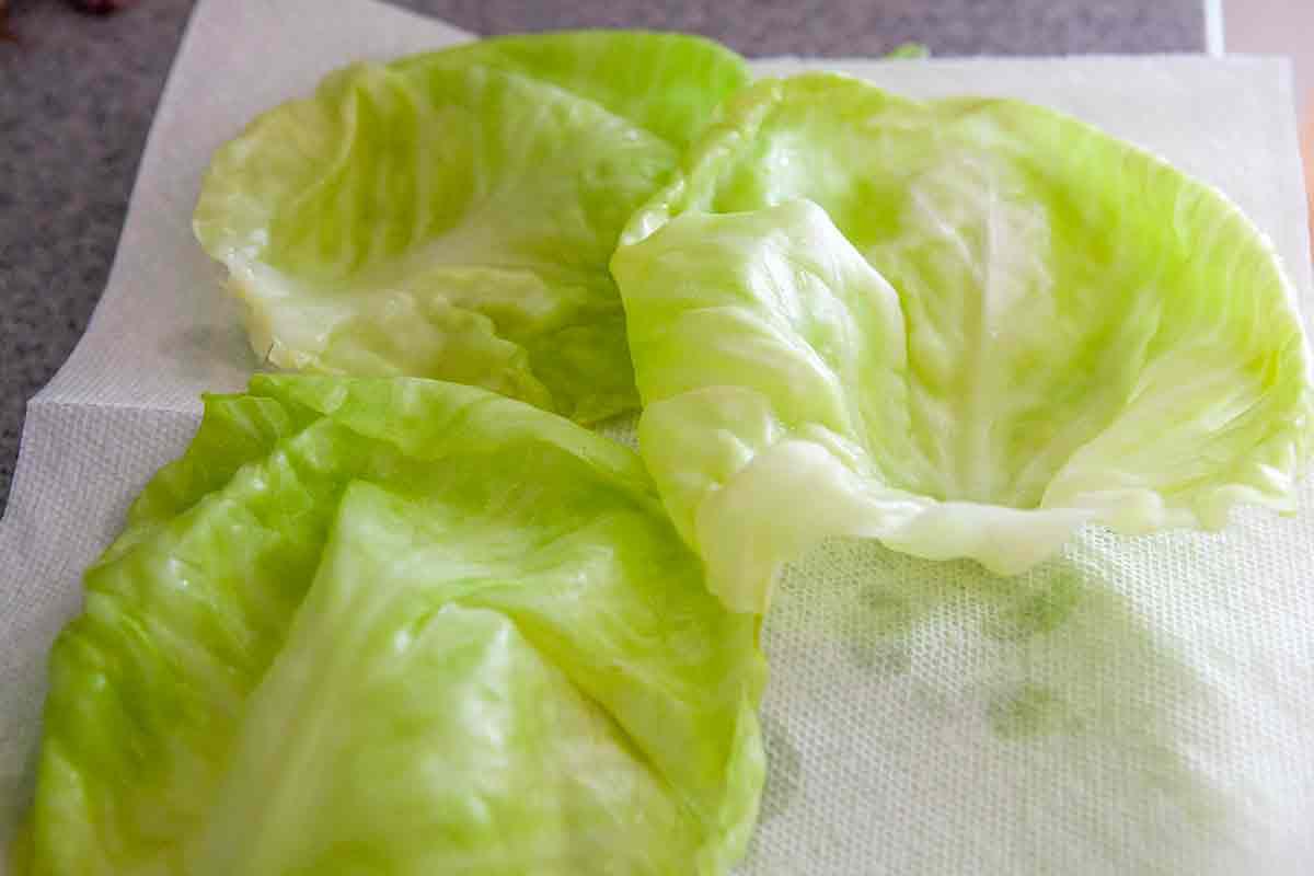 peel off cooked cabbage leaves from the cooked head of cabbage for stuffed cabbage rolls