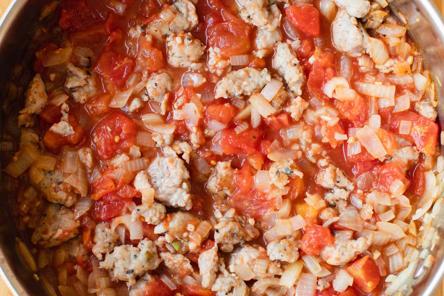 Pan of Tomato, Sausage, and Onions for Zucchini Noodle Recipe