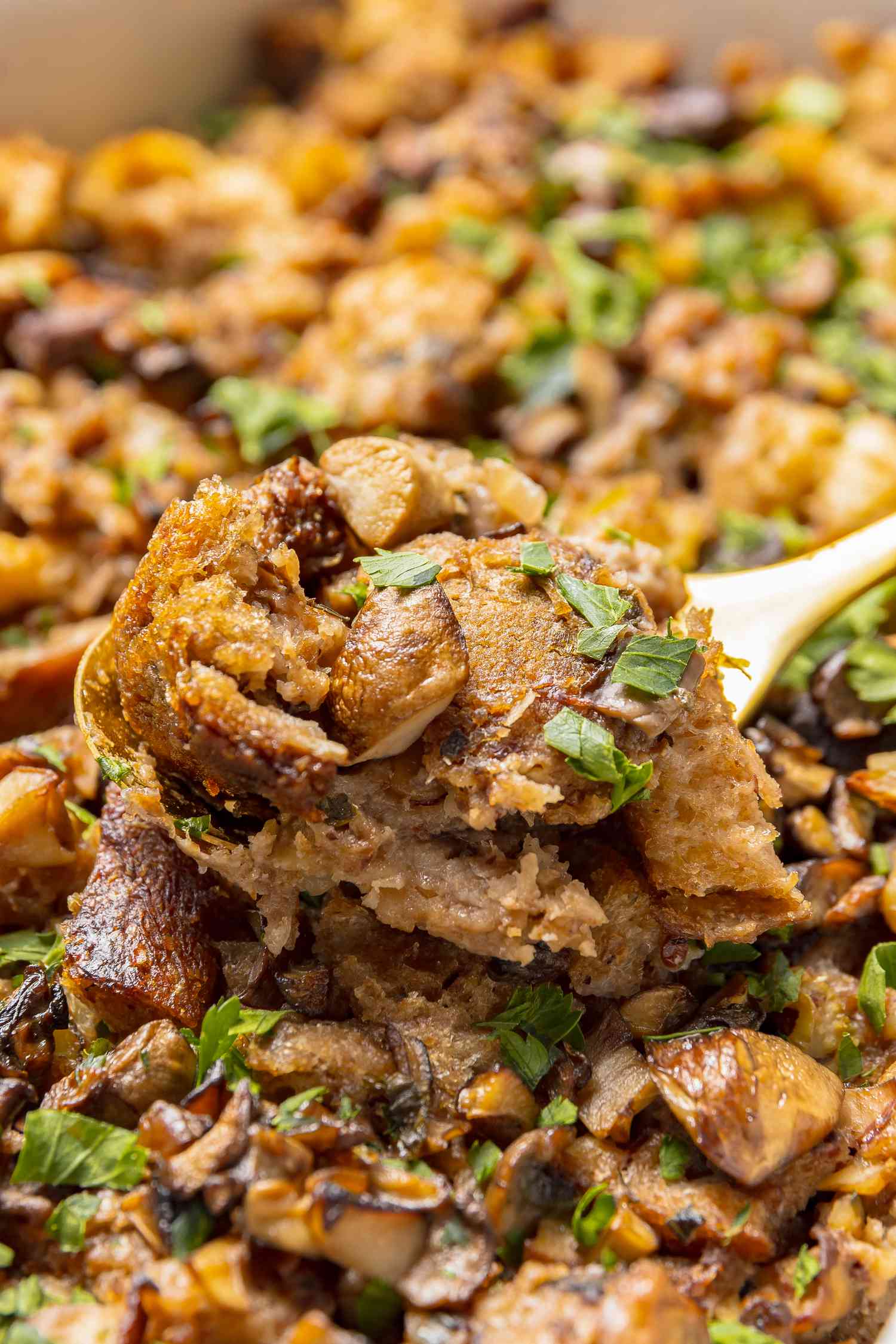 Casserole Dish of Vegan Mushroom Stuffing with Some on a Spoon