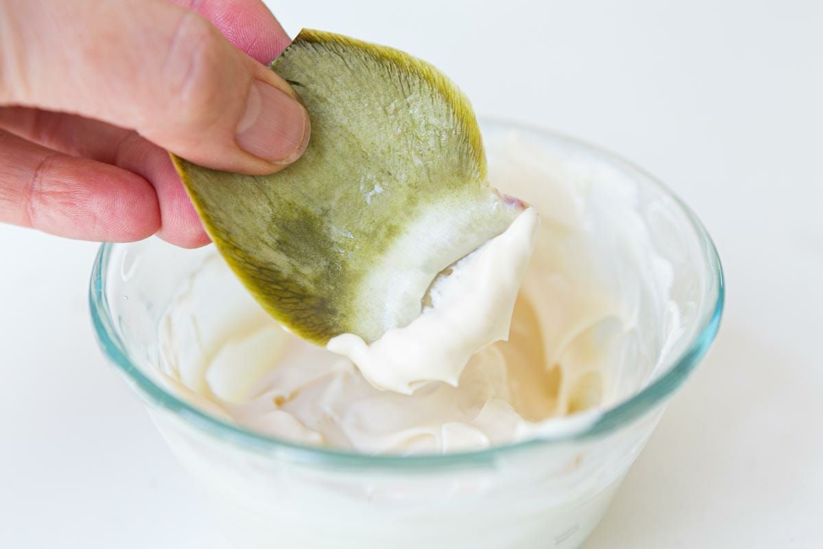Dip the artichoke leaves in mayonnaise