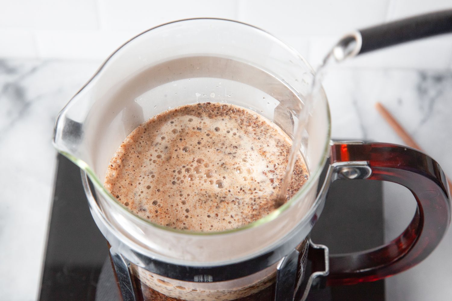 Boiling Water Poured onto Coffee Grounds in a French Press for French Press Coffee Recipe