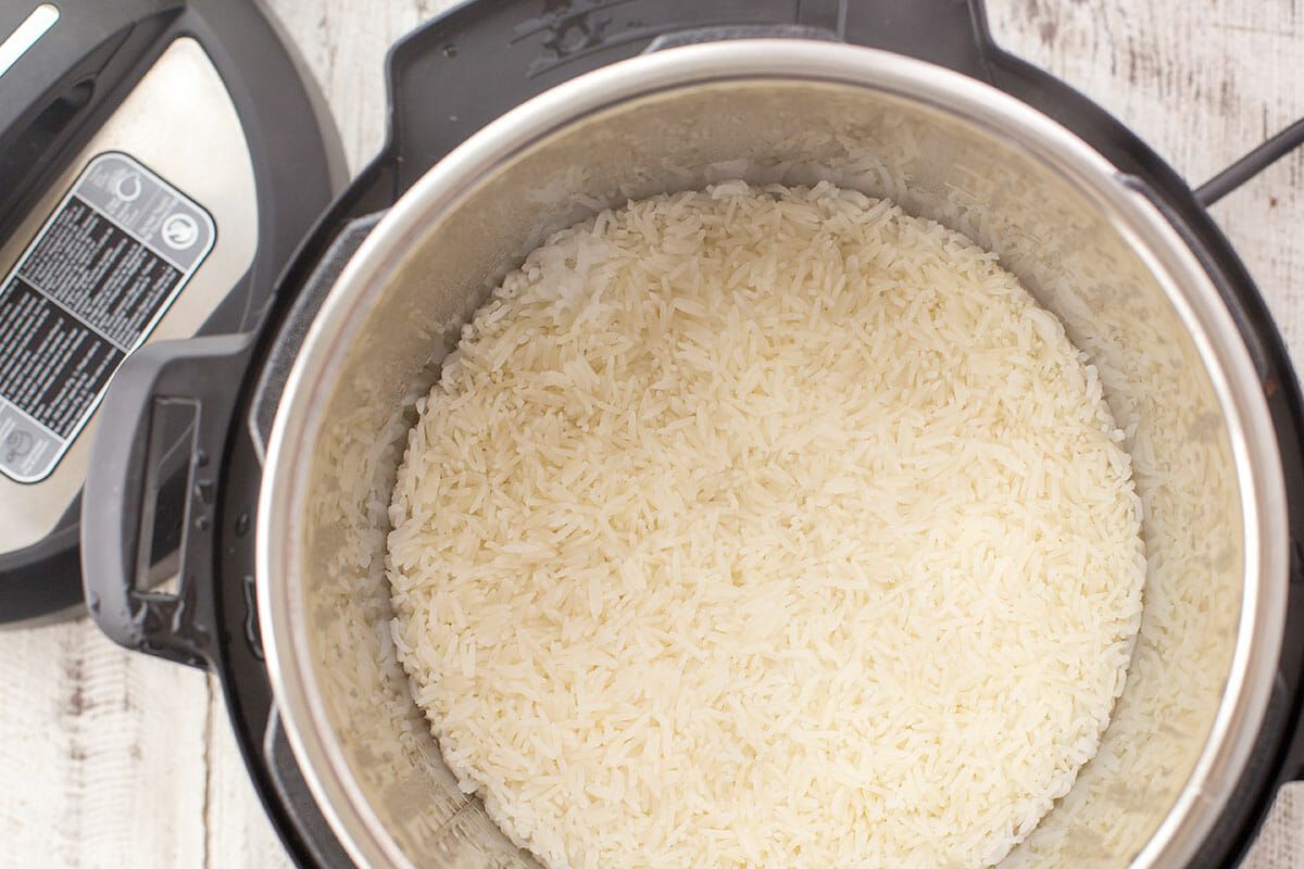 An open Instant Pot seen from overhead with cooked white rice inside