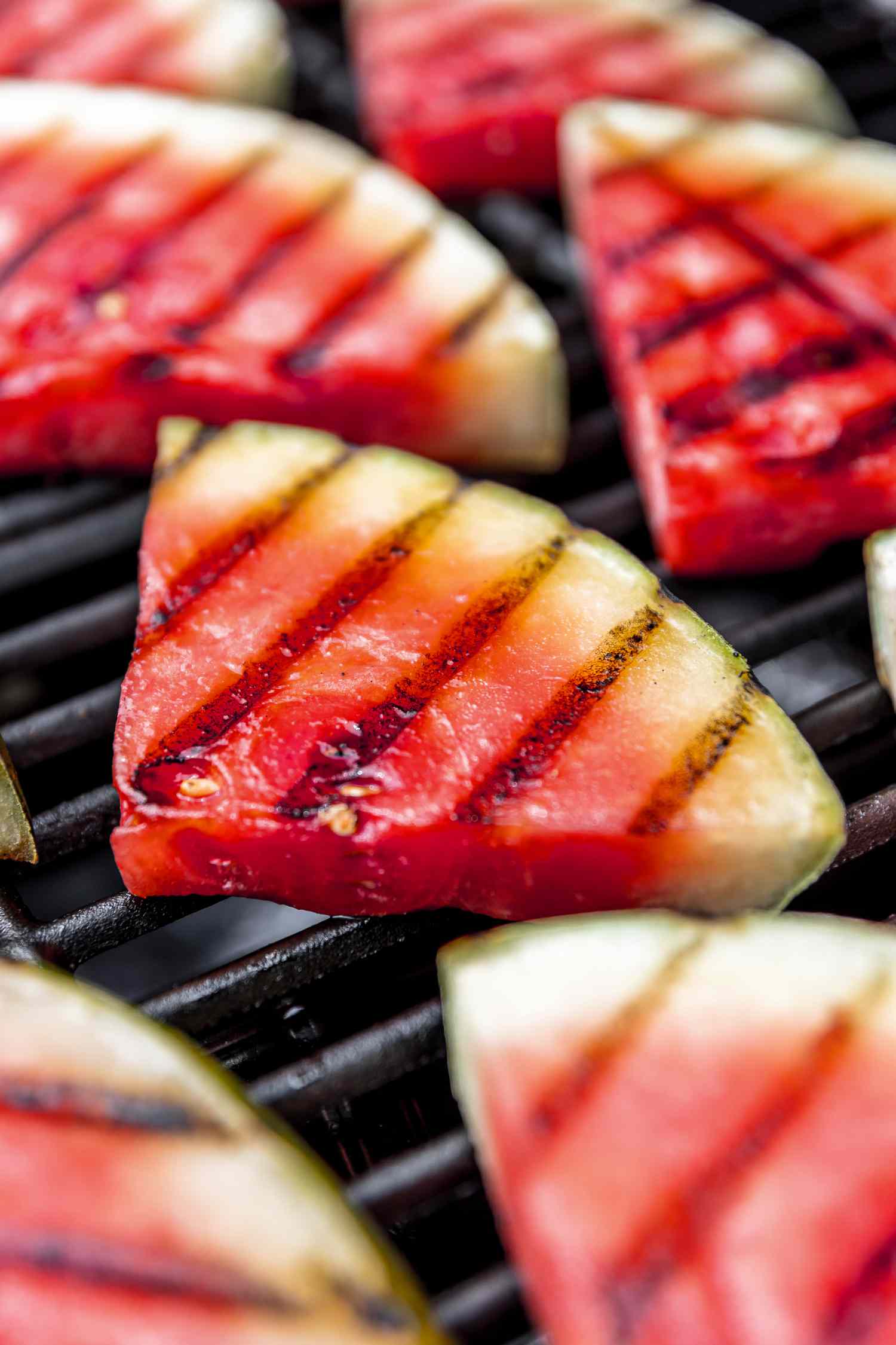 Wedges of watermelon with grill marks on a grill