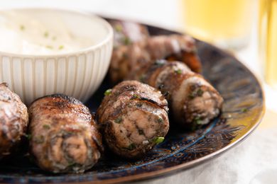 Grilled Bacon-Wrapped Salmon Bites with a Bowl of Lemon Garlic Mayo on a Plate for Grilled Bacon-Wrapped Salmon Bites with Lemon Garlic Mayo 