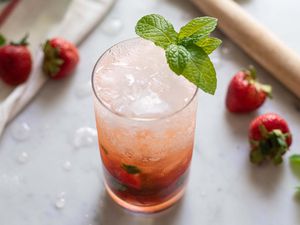 Summer Mojito Cocktail - strawberries on table with mint in glass